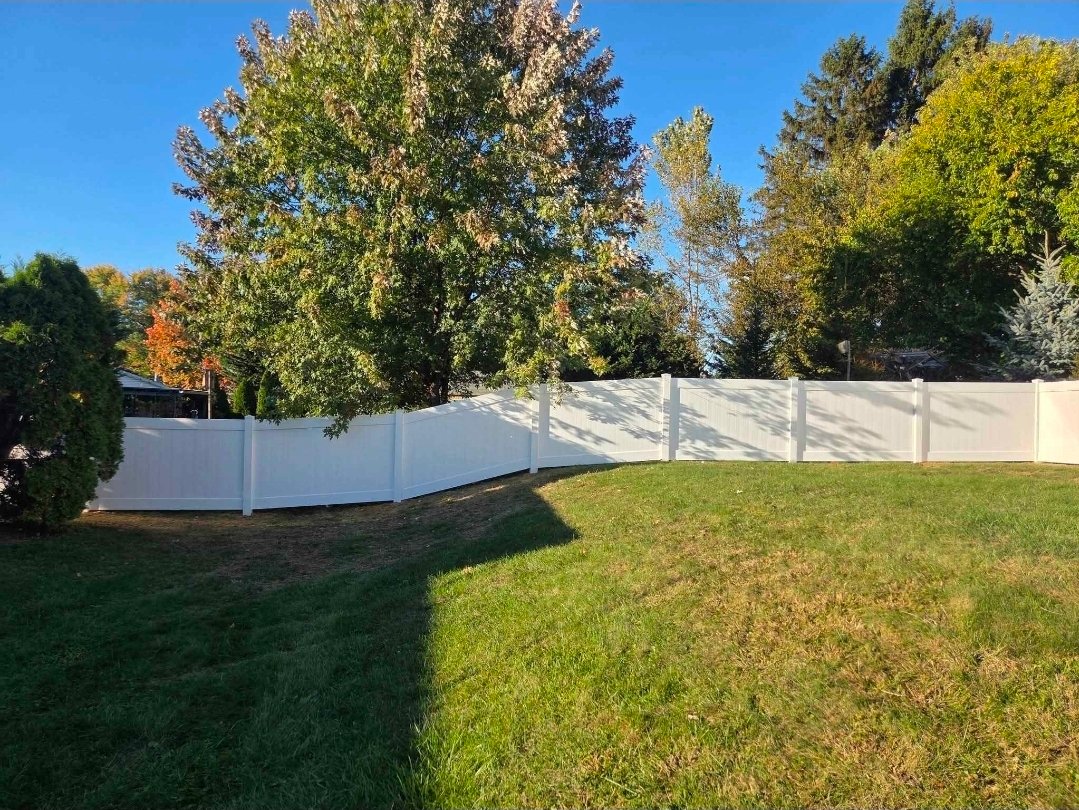 White vinyl privacy fence along property line — PA